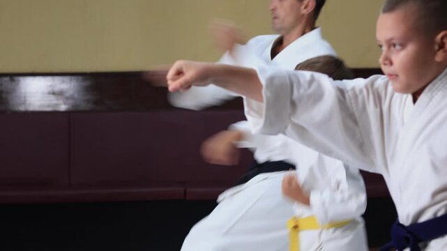 Karate athletes practice striking with a moving hand