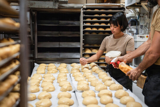 Artisan bakery team proofing dough on tray racks