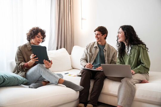 Young adults planning a project together on a sofa