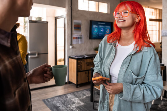 Young professional chatting during office coffee break