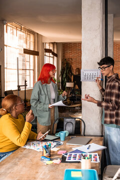 Team planning tasks and deadlines in a bright loft office