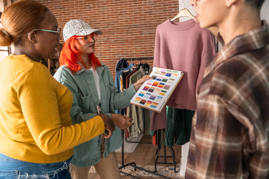 Fashion team choosing color palette for sweater in studio