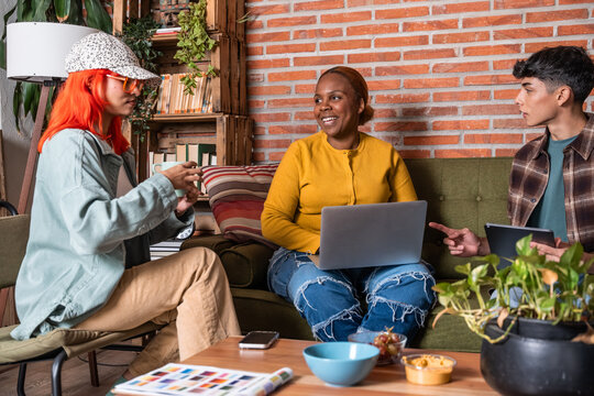 Casual team discussion with laptop in cozy living room