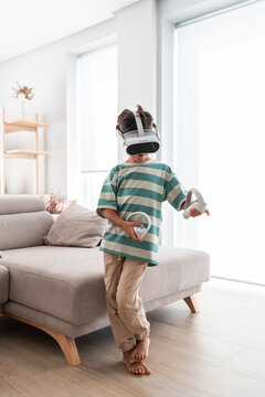 Hispanic family child playing VR game in bright living room