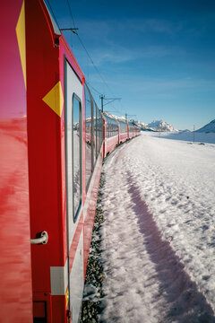 Scenic train journey through snowy alpine landscape