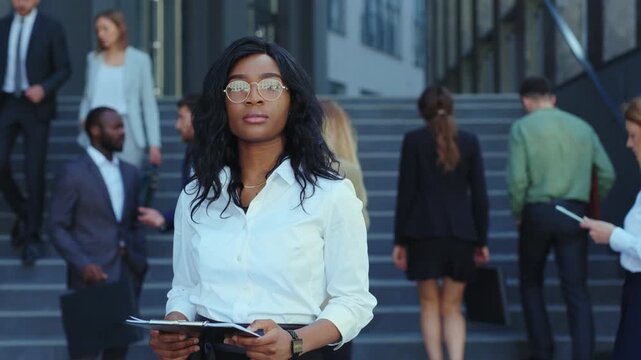 A Professional Businesswoman with a Tablet in a Vibrant Urban Setting Taking Charge of Her Career