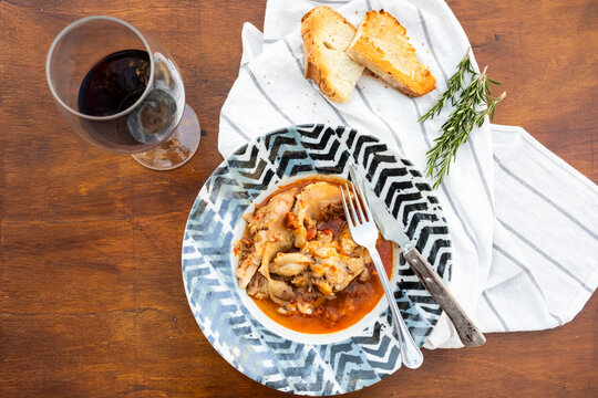 Rustic braised pig's feet stew with bread and red wine
