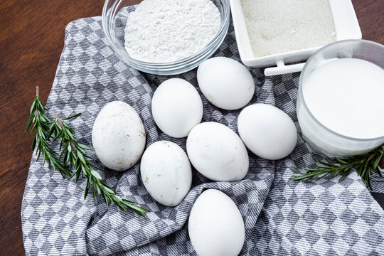 Baking ingredients with eggs, flour and milk on cloth