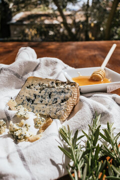 Rustic blue cheese with honey dip and rosemary outdoors