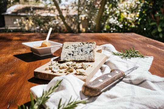 Rustic blue cheese tasting board with honey and rosemary