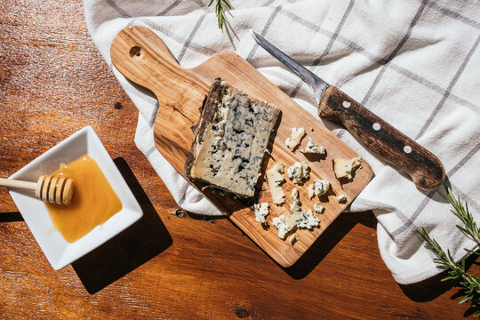 Rustic blue cheese board with honey dip and knife
