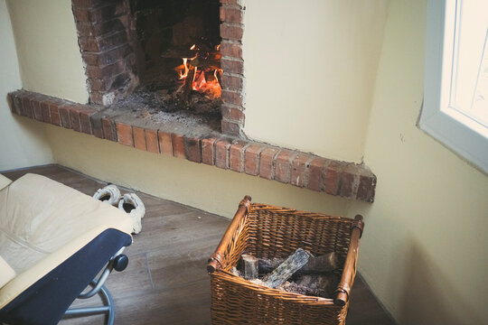 Cozy living room with brick fireplace and wicker log basket