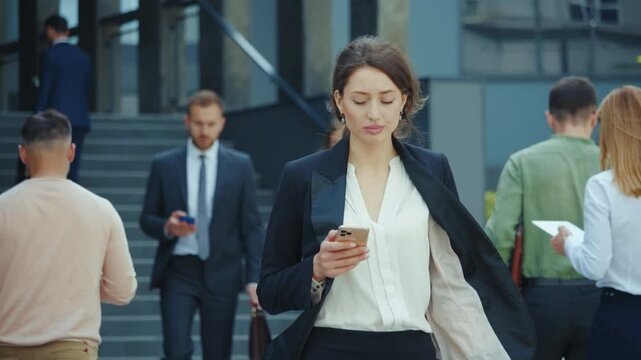 Business professionals walking in a bustling urban environment during the daytime hours