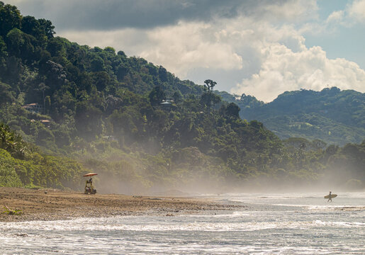 Misty Pacific beach with rainforest hills in Costa Rica