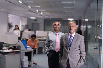 Fototapeta premium Middle Eastern business leaders walking through a modern open-plan office during a corporate meeting