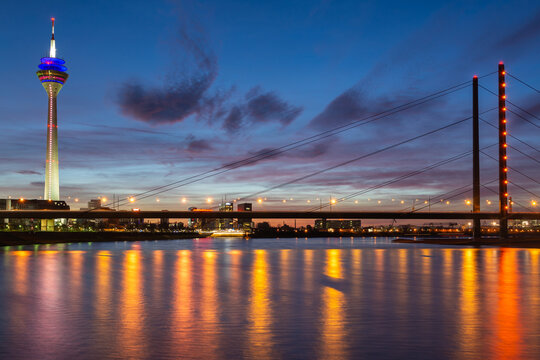 Dusseldorf skyline at dusk with bridge lights on Rhine