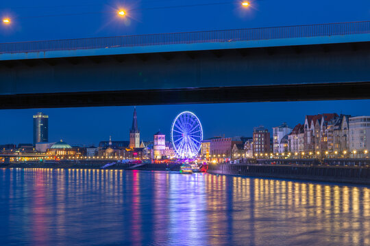 Dusseldorf riverside skyline at night with ferris wheel