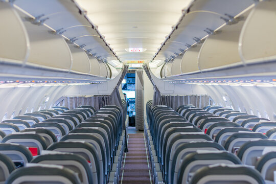 Empty commercial airplane cabin with seats and aisle view