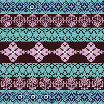 A magnificent tapestry where traditional indigo ikat motifs meet delicate lavender-pink palmettes on fields of chocolate and aqua, creating a timeless and elegant symmetrical dance.