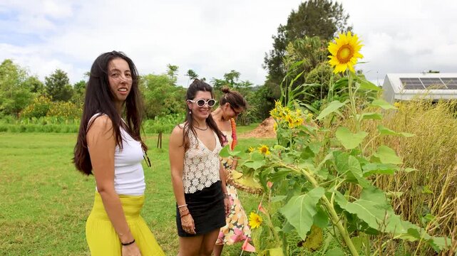 Friends exploring a sunflower field on a sunny day outdoors