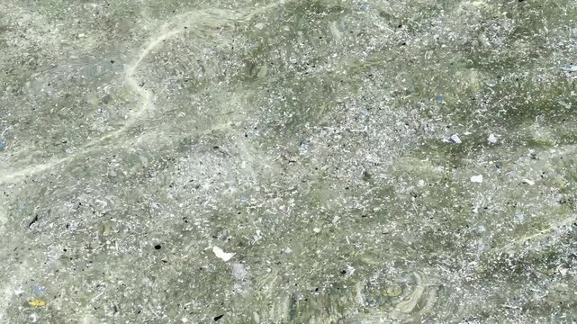 Plastic waste and microplastic debris polluting ocean water surface, environmental pollution concept