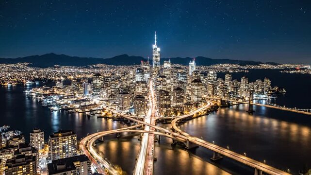 Breathtaking nighttime aerial view of San Francisco city skyline with illuminated buildings and highway infrastructure