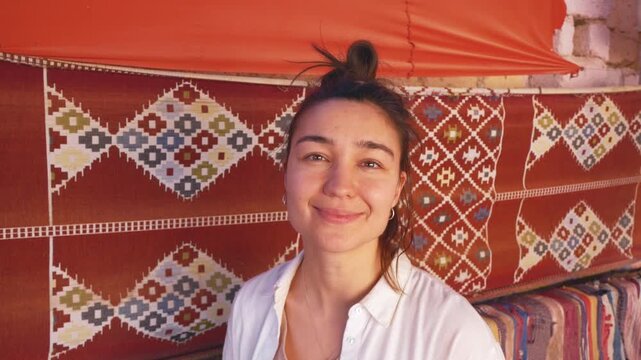 Young Woman in Front of Traditional Ornamental Carpet