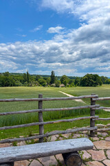 Fototapeta premium Green summer colors light up the countryside among old wooden houses and ancient churches in Ukraine, creating a warm nostalgic atmosphere. 