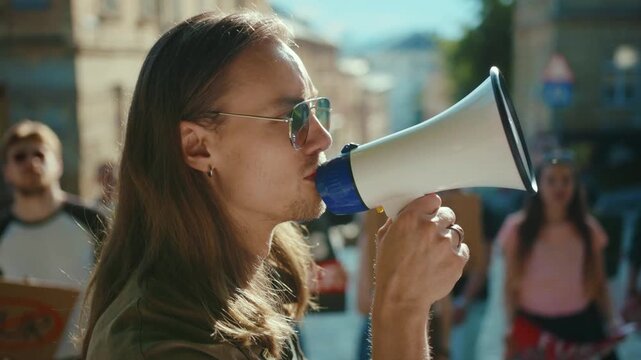 A group of young individuals protesting passionately in an urban environment while holding signs