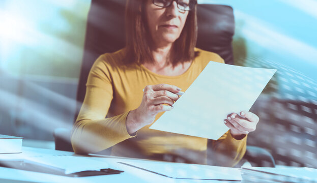 Businesswoman checking document, light effect; light effect