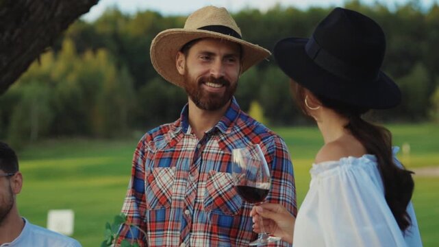 An Inviting Outdoor Gathering with Friends Where Everyone is Enjoying Wine amidst Nature