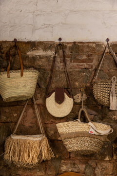 artisanal hand made straw purses for sale at street stall in spain