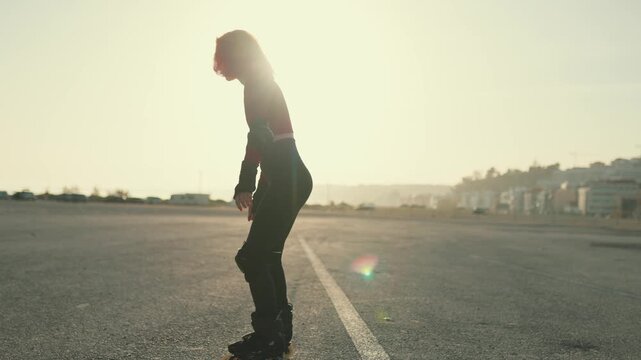 Silhouette of a woman rollerblading at sunset