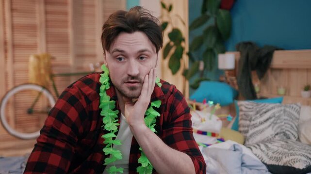 A Frustrated Man Surrounded by Party Decorations in a Bright and Colorful Room Setting
