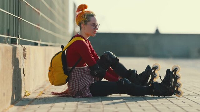 Young woman putting on inline roller skates