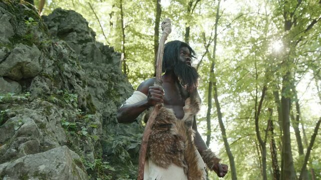 An ancient warrior stands tall amidst a lush forest setting, exuding strength and power
