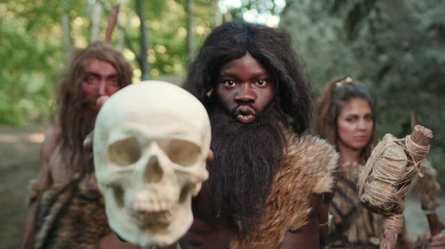 Primitive Tribes in Nature Diligently Holding an Ancient Skull for ceremonial purposes