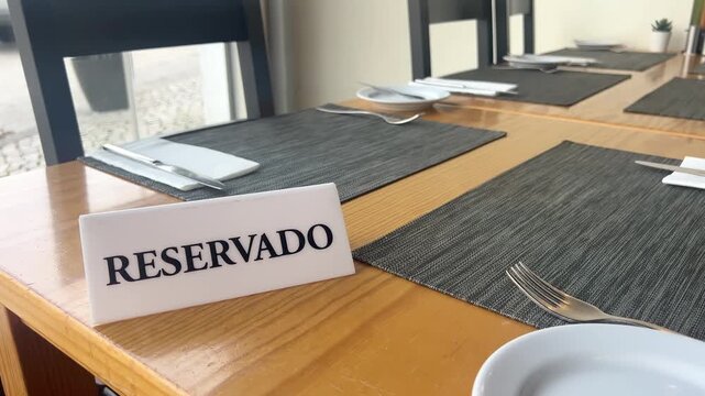 Reserved table sign in restaurant, reservado card on dining table