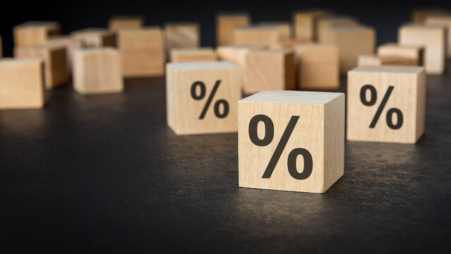 Wooden blocks with percent sign on dark background.