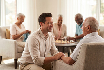Obraz premium Male caregiver providing support and companionship to a senior man in a nursing home