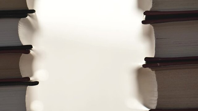 Book background.A symbol of learning and knowledge. Stacks of books in rays of light.4k footage