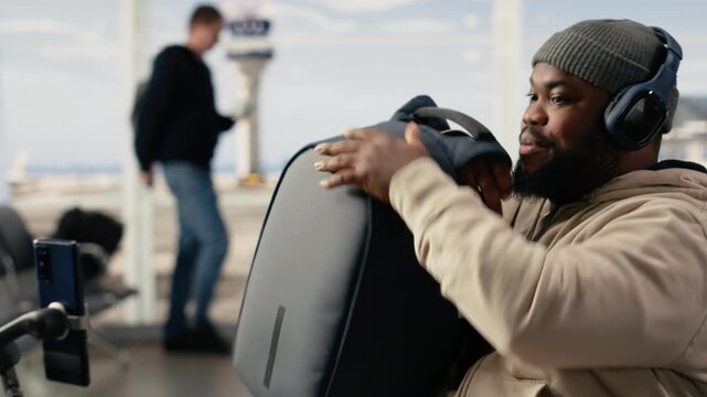 Gen Z influencer, recording video content, on smartphone with tripod, in a busy airport terminal, emphasize travel vlog storytelling. Social media freedom of a digital nomad lifestyle.