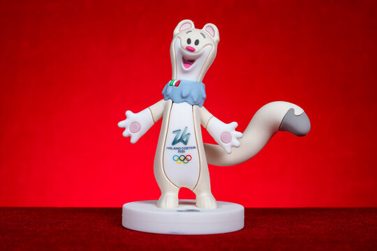 ZHONGSHAN China-April 2 2026: the stoat mascot Tina of the Milano Cortina 2026 Winter Olympics on red background at horizontal composition.