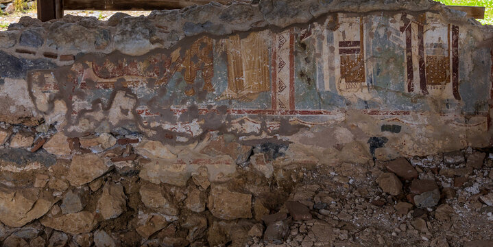 Ancient fresco painting on a partially excavated stone wall in the Platamon Byzantine Castle in Macedonia, Greece