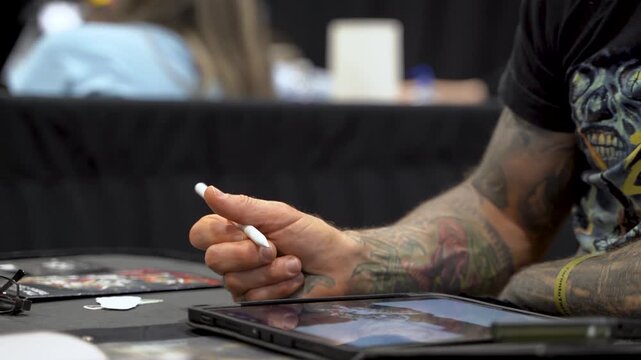 Artist drawing on tablet for tattoo design
