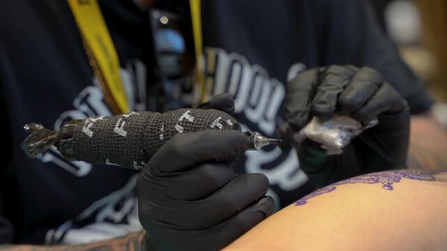 Close up of tattoo artist working on model
