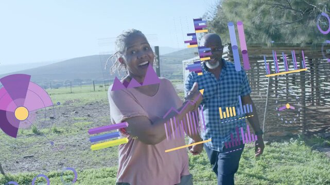 Senior duo walking hand-in-hand, woman pointing AR charts aligning with gestures showing farm data