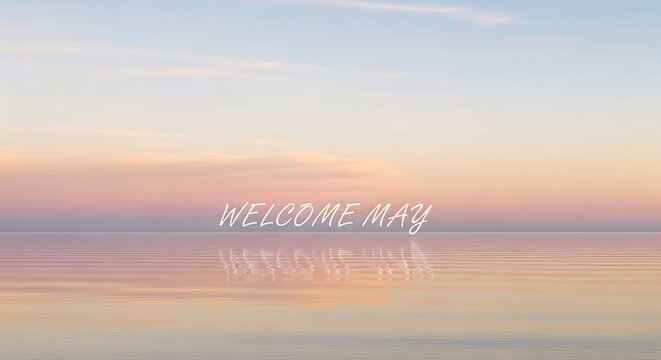 welcome may handwritten message on serene golden beach at sunrise