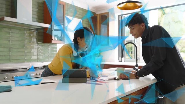 Woman placing tablet, man reviewing swatches at counter for design, blue triangle sweeping smiling