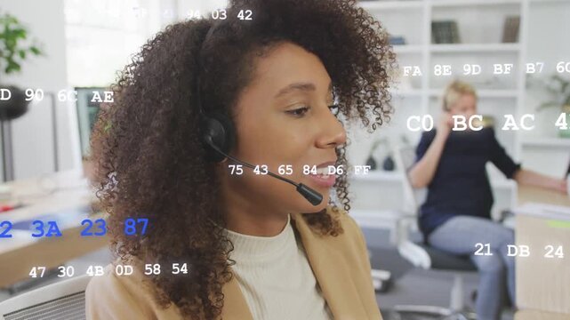 Call agent receiving headset call, handling client while smiling, hex graphics drifting over desk